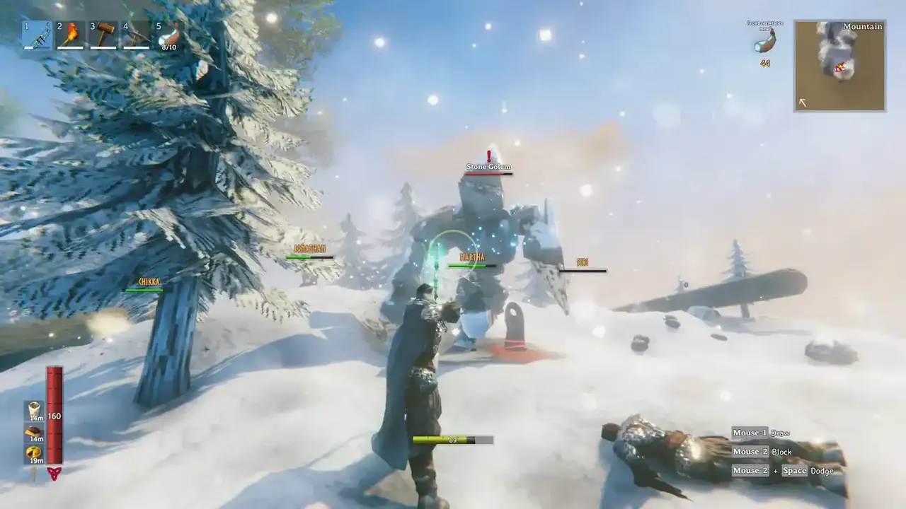 Valheim players fighting a Stone Golem in the snowy Mountains biome